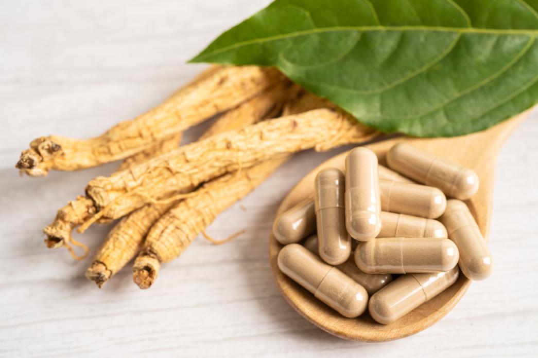 Ginseng and vegetarian capsules on the table.