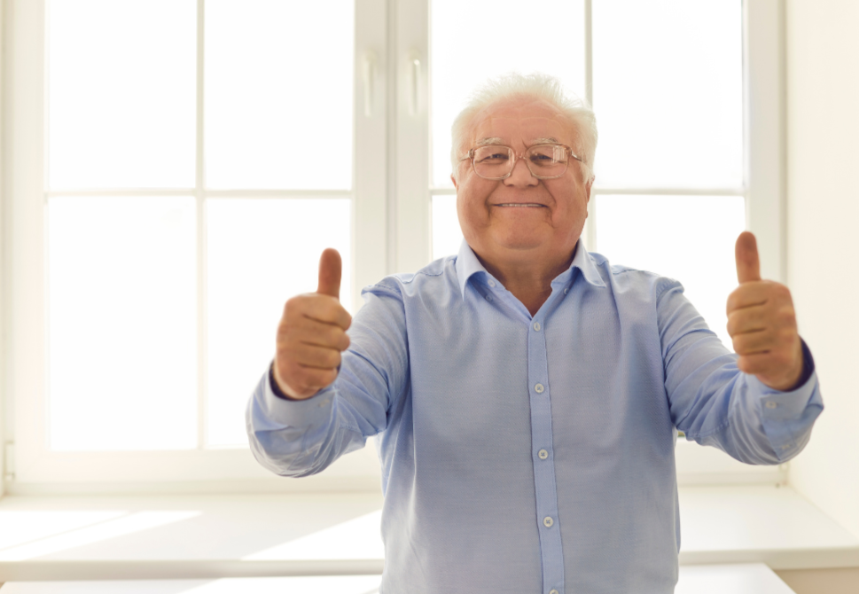 Happy old man doing thumbs up.