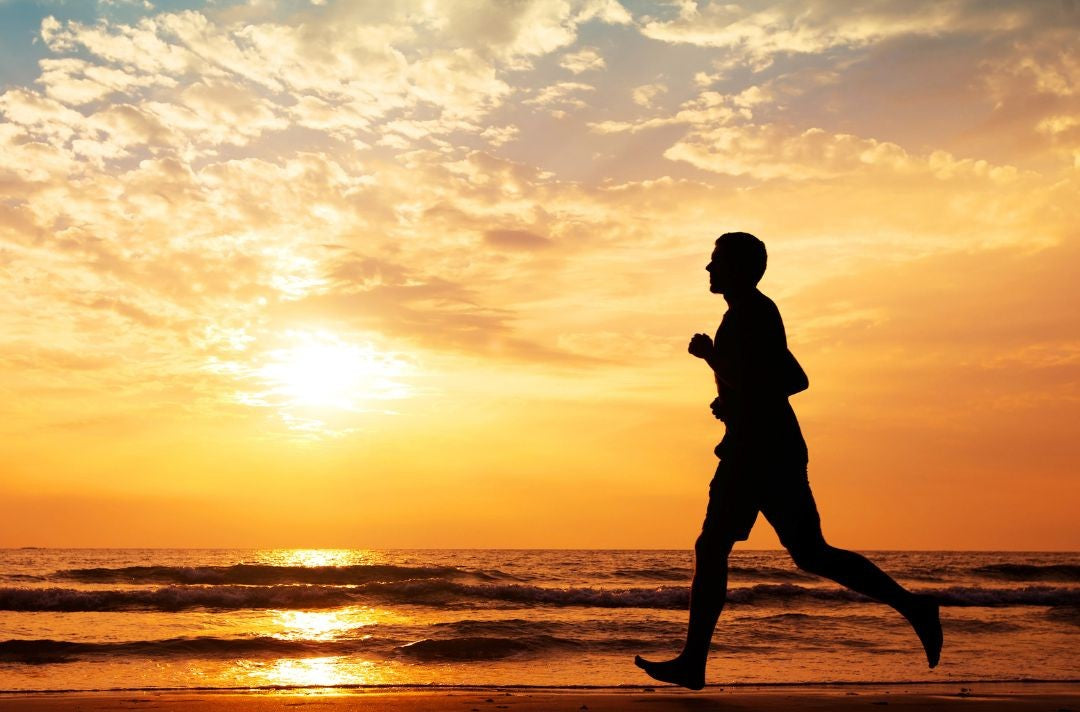 A man jogging on shore.